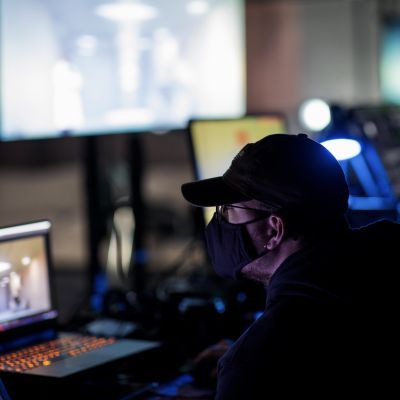 Video Design student working at a computer backstage